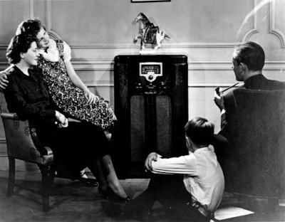 Old Black and White Photo of a Family listening to the Radio (1930s / 1940s).