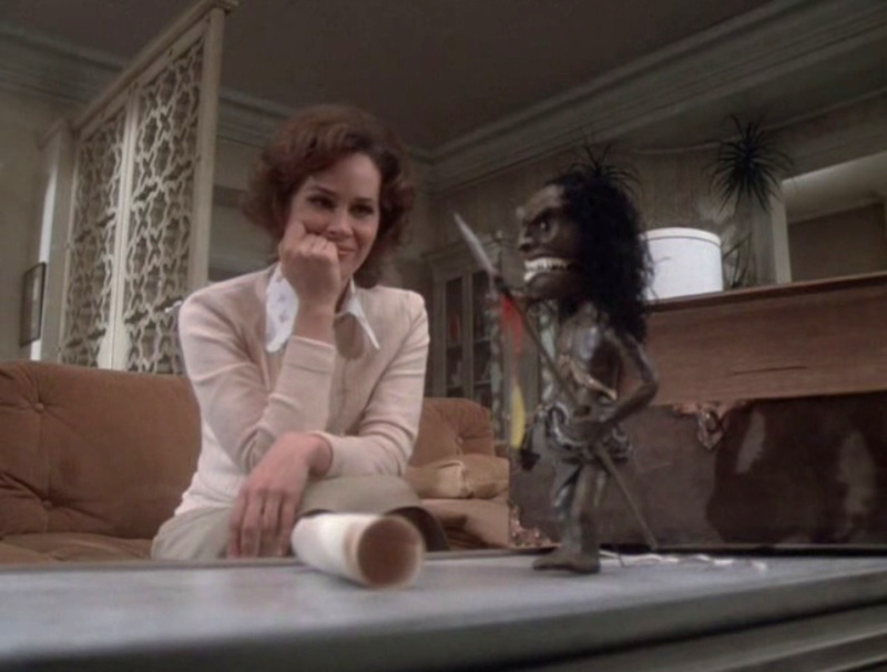 Karen Black admires He Who Kills, a Zumi fetish doll she's bought for her boyfriend in "Amelia."