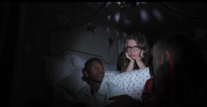 Brooks (BJ Tanner) struggles to make do with only the light from a cell phone, along with Rose, and Azaleah (the D'Ambrosio twins)