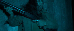 Steve (Keekee Suki) hides behind his gun, in Don't Break the Rules (2024)