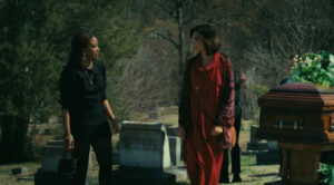 Tare (Lauren Chanel) confrontes Maeve (Shazia Pascal) in the cemetery (Tarot Curse 2025)