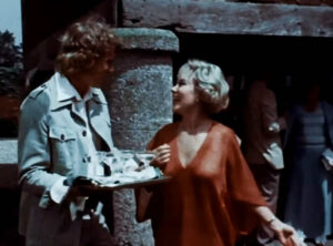 Mrs. Amworth (Glynis Johns) and David (Pip Miller) at the garden party.