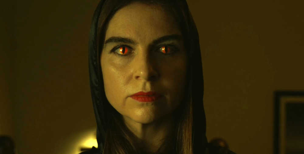 Charlotte Marshall with snake eyes in horror film The Cellar (2024)